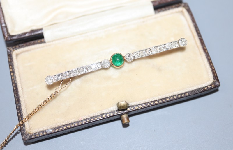 An early 20th century yellow metal, cabochon emerald and millegrain set diamond bar brooch, 52mm, gross 3.6 grams.